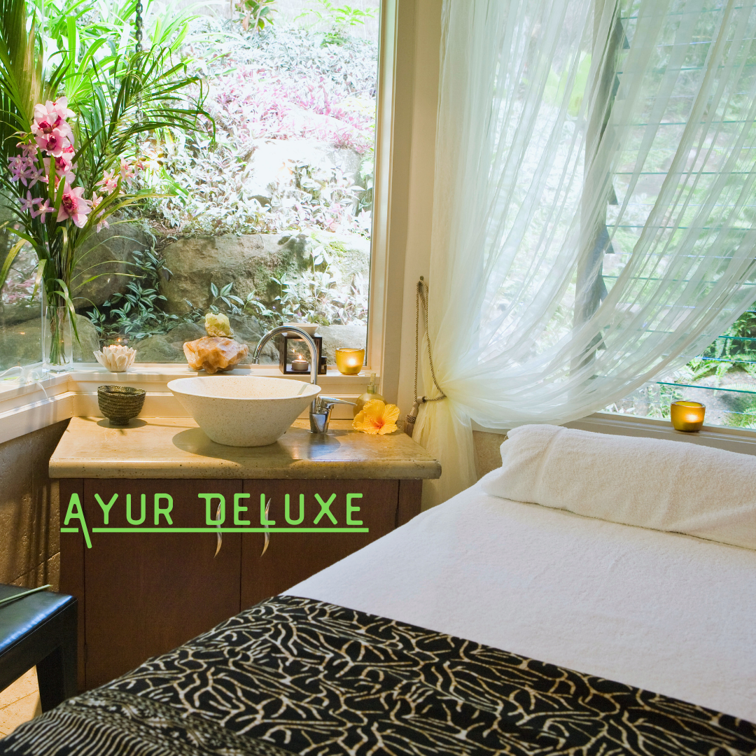 Ayur Deluxe room with flowers and wellness setup
