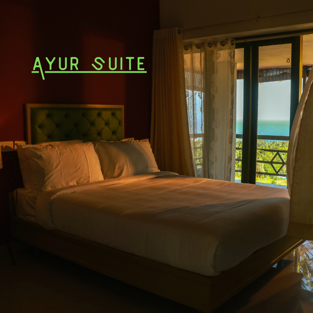 Ayur Suite bedroom with large bed and balcony view