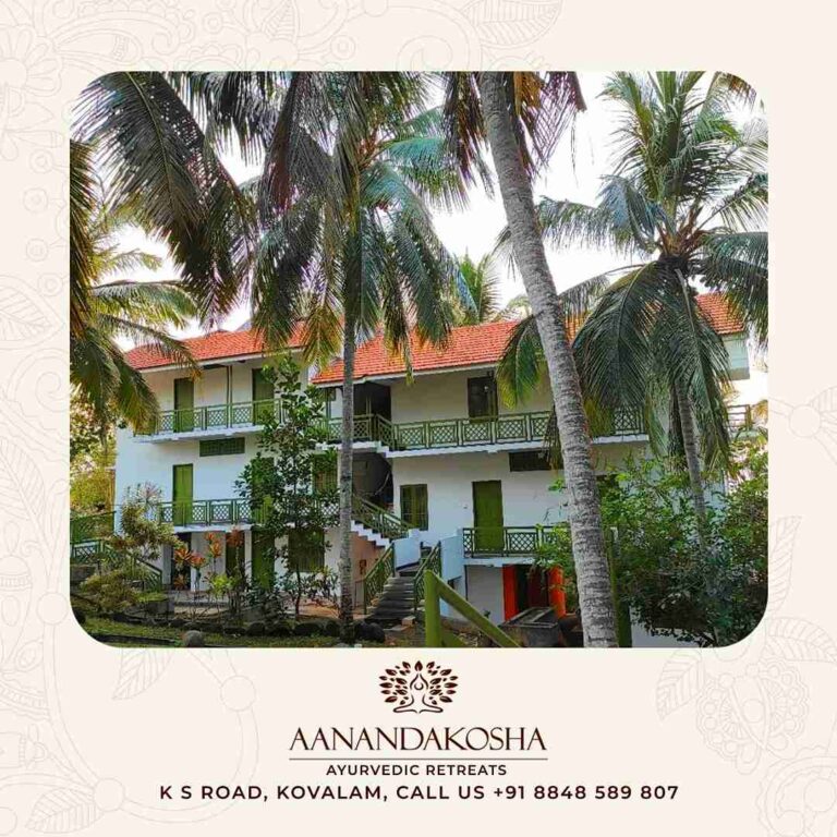 Aanandakosha Ayurveda Retreat exterior facade framed by coconut trees