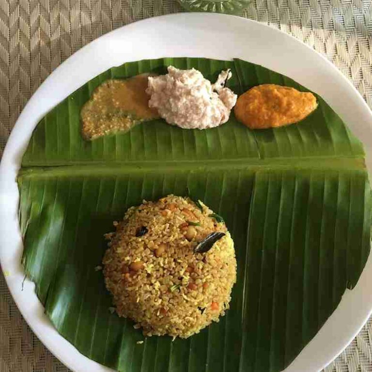South Indian breakfast vada served on banana leaf with chutneys