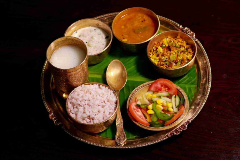 Traditional Kerala Ayurvedic meal thali with rice, curry, and buttermilk