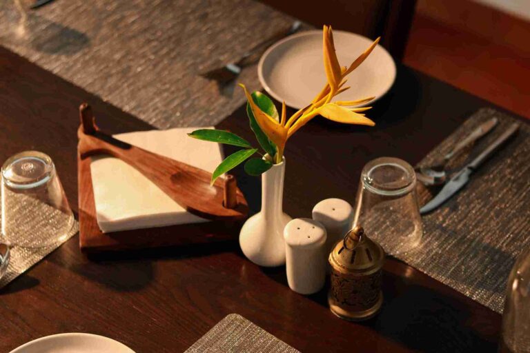 Table setting with flower decoration at Anandakosha Ayurveda Retreat